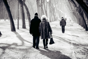 elderly couple walking down Miami path during winter